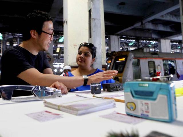 Artist Kyungwoo Chun explains describes his artwork to a visitor at the ongoing Kala Ghoda Arts Festival at CST railway station in Mumbai. (Pratham Gokhale/HT photo)