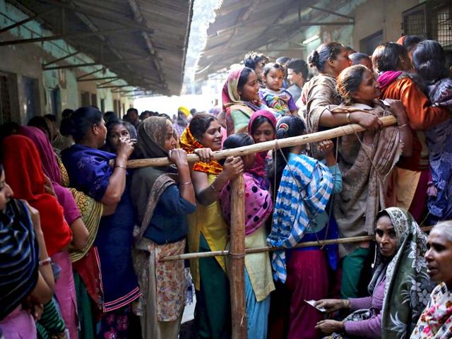 Voters line up to cast their votes at a polling station during the state assembly election in New Delhi. (Reuters)