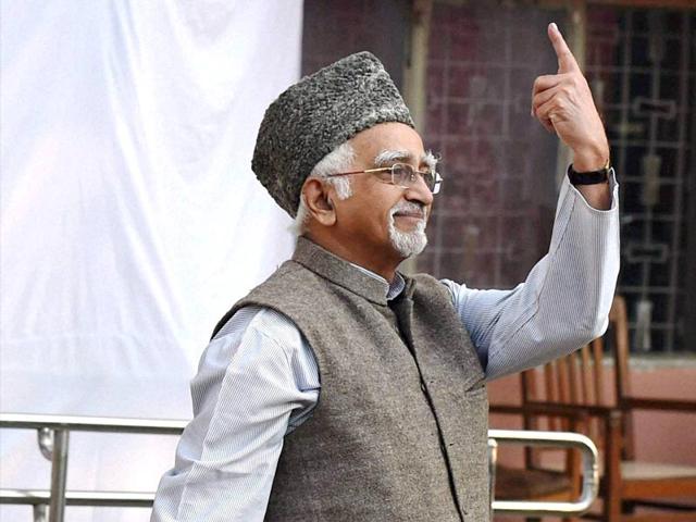 Vice president Mohd Hamid Ansari shows his inked finger after casting his vote for Assembly elections in New Delhi. (PTI Photo)