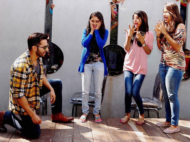Bollywood actor Varun Dhavan dances with fans during a promotional event for Badlapur in Ahmedabad on Monday. (PTI Photo)