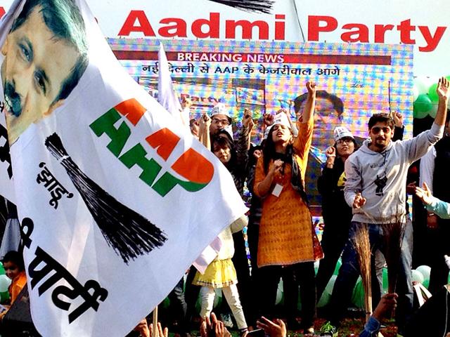 AAP-volunteers-wield-brooms-the-party-s-poll-symbol-as-they-celebrate-outside-the-Patel-Nagar-party-office-Arvind-Yadav-HT-Photo AAP-volunteers-wield-brooms-the-party-s-poll-symbol-as-they-celebrate-outside-the-Patel-Nagar-party-office-Arvind-Yadav-HT-Photo