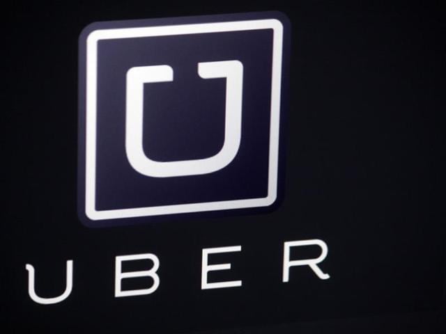 The-Uber-smartphone-app-used-to-book-taxis-using-its-service-is-pictured-over-a-parking-lot-AFP-photo The-Uber-smartphone-app-used-to-book-taxis-using-its-service-is-pictured-over-a-parking-lot-AFP-photo
