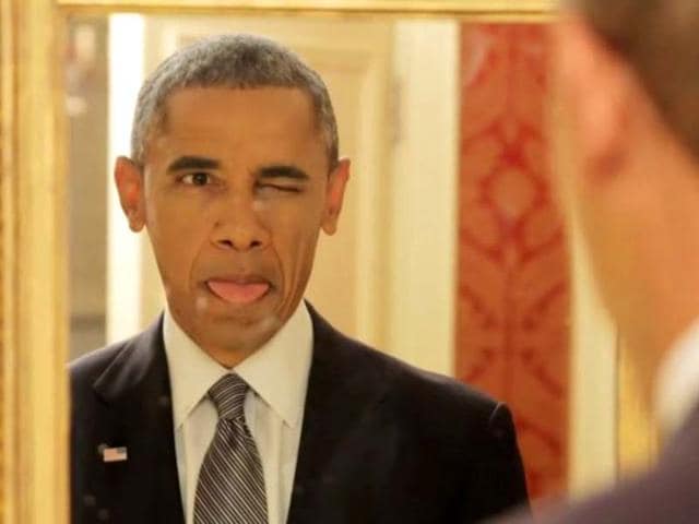 US-President-Barack-Obama-sticks-his-tongue-out-while-checking-himself-out-in-a-mirror-Photo-courtesy-BuzzFedd-Motion-Pictures