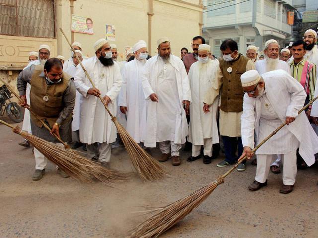 Members of Dawoodi Bohra community take part in a cleanliness drive, in Bhopal on Saturday. (PTI photo)