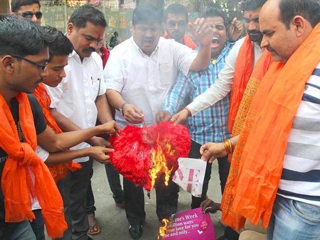 Vishwa Hindu Parishad activists protest against Valentine's Day and burn greeting cards in Thane. (Praful Gangurde/HT photo)