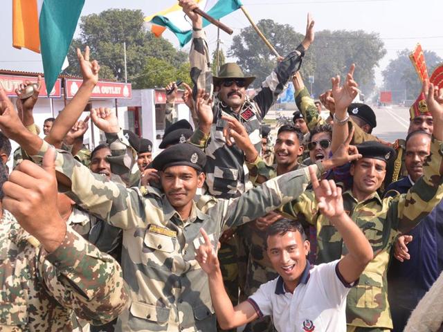 BSF personnel celebrate as they watch a live broadcast of the Cricket World Cup match between India and Pakistan at Border Post in Amritsar. Sameer Sehgal/HT