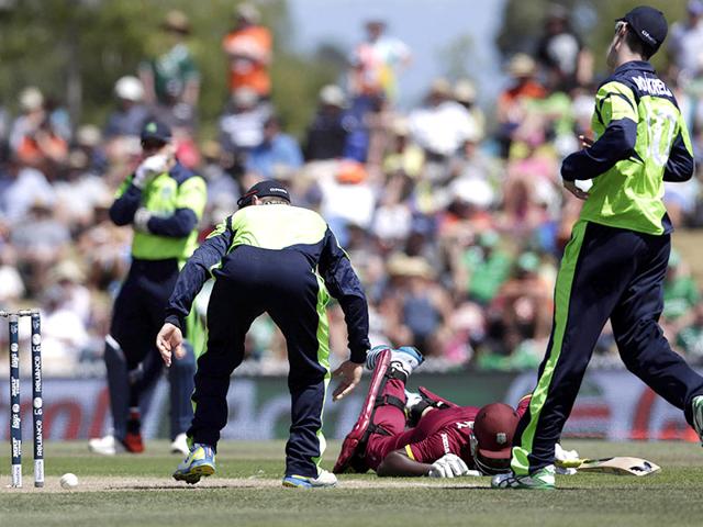 West Indies batsman Darren Sammy makes his ground during their Cricket World Cup match, watched by Ireland's captain William Porterfield and George Dockrell (R) in Nelson. Reuters