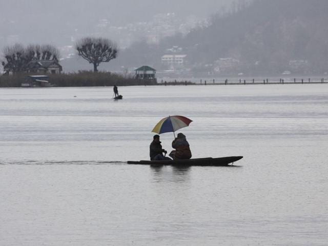 Tourists ride on traditional boats as clouds hover over the Dal Lake in Srinagar. Waseem Andrabi/HT
