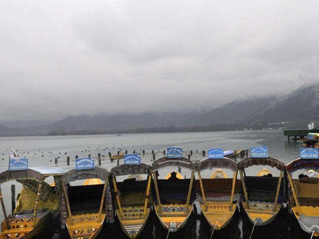 Empty traditional boats waits for tourists as rain clouds hover over the Dal Lake in Srinagar. Waseem Andrabi/HT