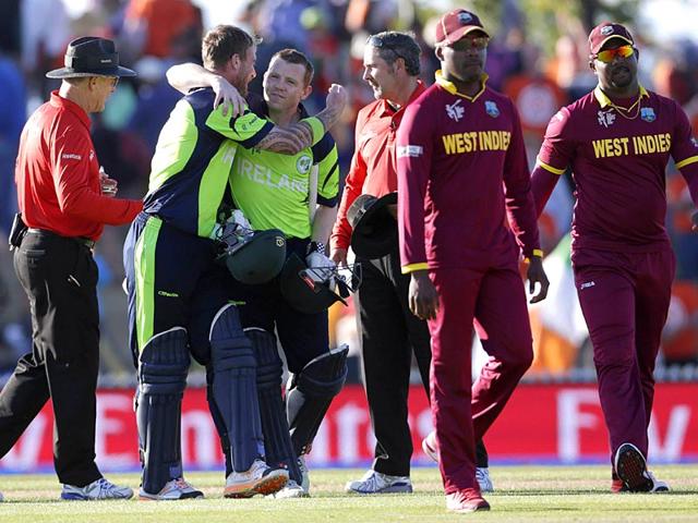 Ireland's John Mooney (2nd L) hugs teammate Niall O'Brien (3rd L) after beating the West Indies for the first time in their Cricket World Cup match in Nelson. (Reuters)