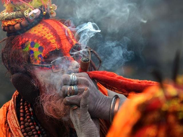A Nepalese Hindu sadhu smokes marijuana from a clay pipe as a holy offering for Lord Shiva during the Shivaratri festival in Kathmandu. (AFP photo)