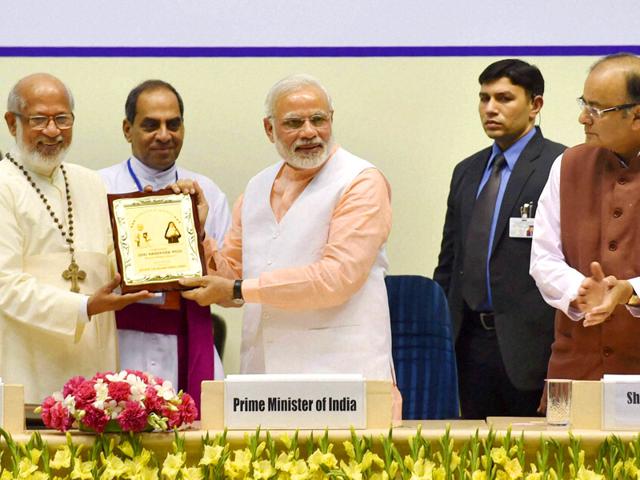 Prime-Minister-Narendra-Modi-receives-a-memento-by-Cardinal-George-Alencherry-during-a-function-to-celebrate-the-elevation-to-sainthood-of-Kuriakose-Elias-Chavara-and-Mother-Euphrasia-as-Union-finance-minister-Arun-Jaitley-looks-on-in-New-Delhi-PTI-Photo Prime-Minister-Narendra-Modi-receives-a-memento-by-Cardinal-George-Alencherry-during-a-function-to-celebrate-the-elevation-to-sainthood-of-Kuriakose-Elias-Chavara-and-Mother-Euphrasia-as-Union-finance-minister-Arun-Jaitley-looks-on-in-New-Delhi-PTI-Photo