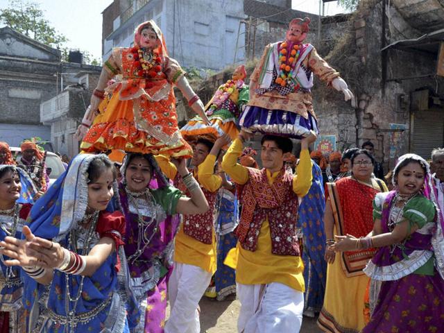 Artistes perform traditional 'Gangaur' dance during 'Shiv Barat' procession taken out on Mahashivratri, in Bhopal on Tuesday. (PTI photo)
