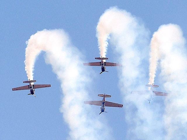 Russia's aerobatic display team " Yakovlevs" performs a daring manoeuvre during the inauguration of the Aero India 2015. (PTI Photo)