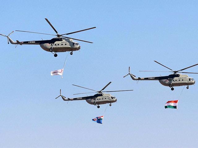 Indian Air Force helicopters fly past with Indian Tri Colour during the inauguration of the Aero India 2015. (PTI Photo)