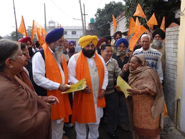 Shiromani-Akali-Dal-candidate-Manmohan-Singh-Walia-and-party-leader-Sarabjit-Singh-Makkar-in-yellow-turban-campaigning-in-Ward-4-of-Kapurthala-on-Wednesday-Parampreet-Singh-Narula-HT