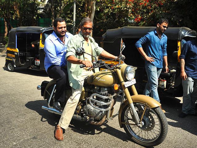 Nana Patekar, with his son Malhar Patekar as passenger, rides a 'bullet' motor-cycle to promote Ab Tak Chappan 2. (AFP Photo)