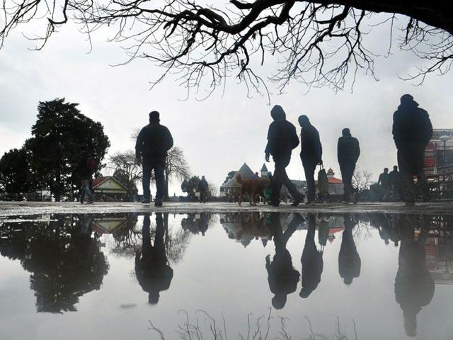 People walking during rain at Ridge in Shimla. Santosh Rawat/HT