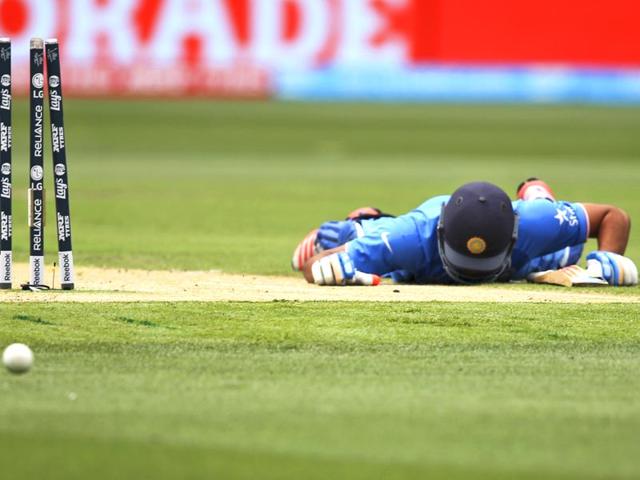 Rohit Sharma lies on the ground after he was run out during the World Cup pool B match against South Africa in Melbourne. (AP Photo)
