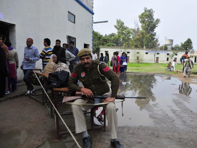 A policeman on duty outside a polling booth in Santa Majra in Kharar during civic polls on Wednesday. Gurpreet Singh/HT