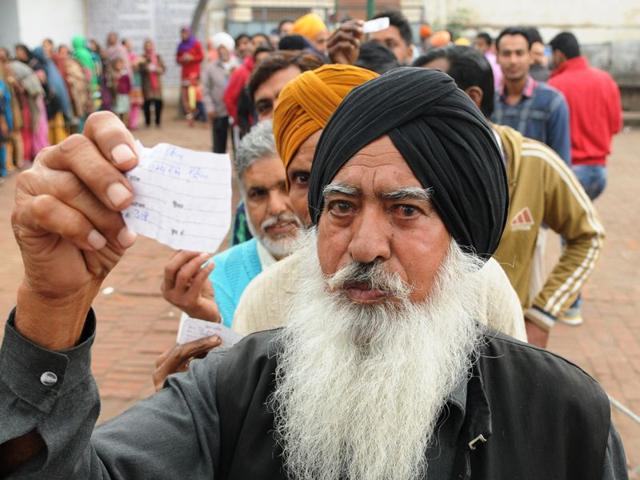 Voters showing voters slips at a polling booth during civic polls in Patiala on Wednesday. Bharat Bhushan/HT