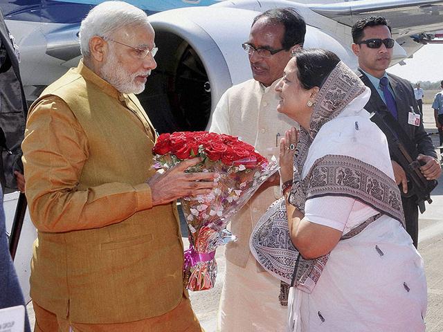 MP chief minister Shivraj Singh Chouhan and Indore mayor Malini Gaud welcome Prime Minister Narendra Modi on his arrival in Indore on Thursday. (PTI photo)