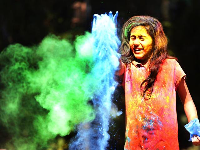 A young kid plays Holi, the festival of colours, Holi at Dadar in Mumbai. (Kalpak Pathak / Hindustan Times)