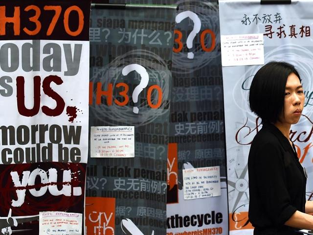 A-woman-walks-past-placards-highlighting-the-missing-Malaysia-Airlines-flight-MH370-during-a-remembrance-event-in-Kuala-Lumpur-An-investigation-into-missing-flight-MH370-has-found-no-red-flags-relating-to-the-crew-or-mechanical-issues-according-to-an-interim-report-released-that-shed-no-new-light-on-the-cause-of-the-disappearance-AFP-Photo