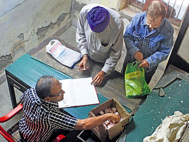 People-at-the-Maharashtra-State-Excise-Depot-to-get-their-quota-of-opium-Arijit-Sen-HT-photo