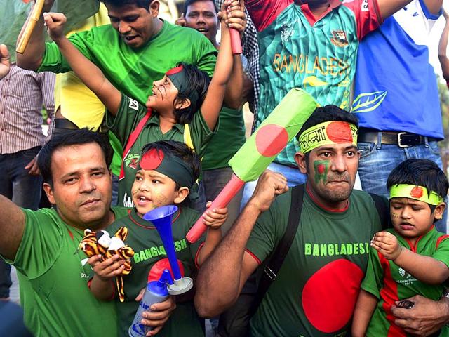 Bangladesh cricket fans pose for a photograph as they celebrate their national team's win against England in the ICC World Cup 2015 in Dhaka. (AFP Photo)