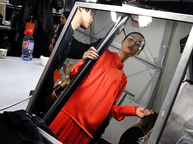 Kenzo: A model checks herself over before walking out for Kenzo.