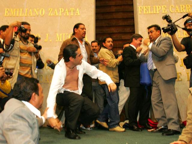 Mexico's deputy Faustino Soto (R) of the Partido de la Revolucion Democratica (PRD) fights with deputy Francisco Dominguez (L) of the National Action Party (PAN) in the lower chamber of Congress on 28 Nov 2006 in Mexico City. (AFP Photo)