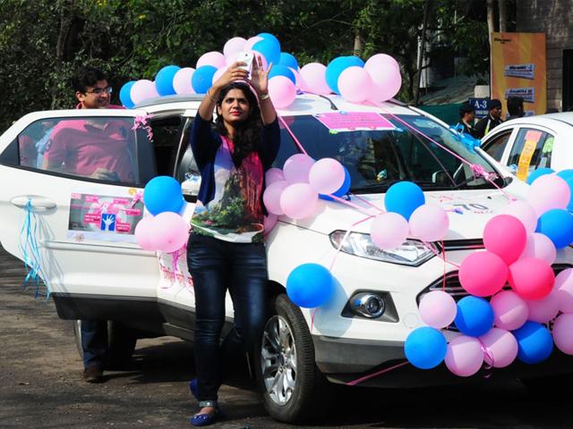 A woman takes a selfie with her car before taking part in a women's car rally in Bhopal on Sunday. (Mujeeb Faruqui/HT photo)