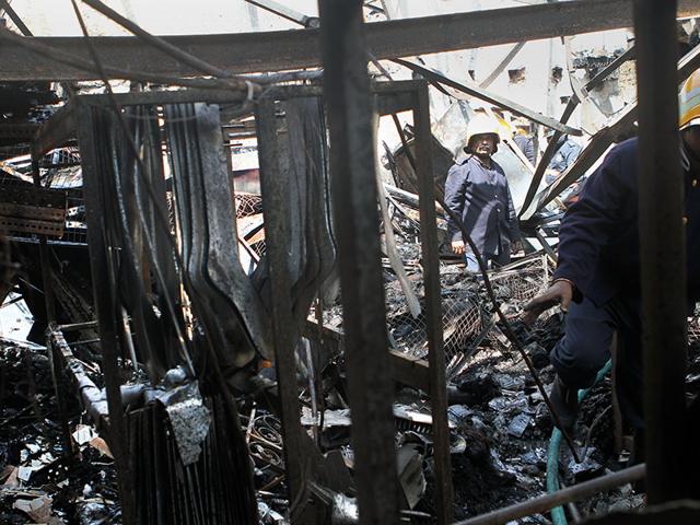 Fire brigade members douse fire at a socks factory in Jogeshwari that caught fire on Sunday night, in Mumbai. (Arijit Sen/HT photo)