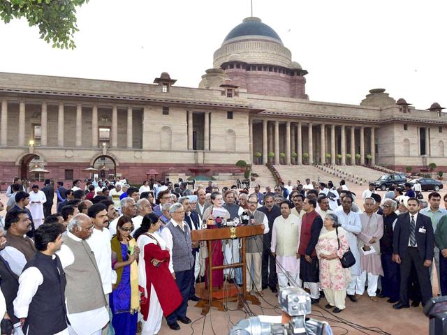 Congress president Sonia Gandhi, accompanied by former PM Manmohan Singh and a delegation of opposition parties' leaders, addresses the media after meeting President Pranab Mukherjee over the controversial Land Acquisition Bill, at Rashtrapati Bhavan in New Delhi . (PTI photo)