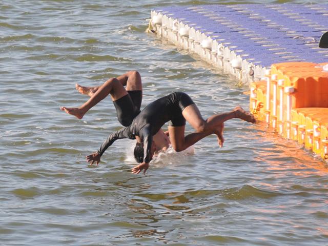 Students of water sports department jump into Upper Lake during their practice session at the Boat Club in Bhopal on Wednesday. (Bidesh Manna/HT photo)