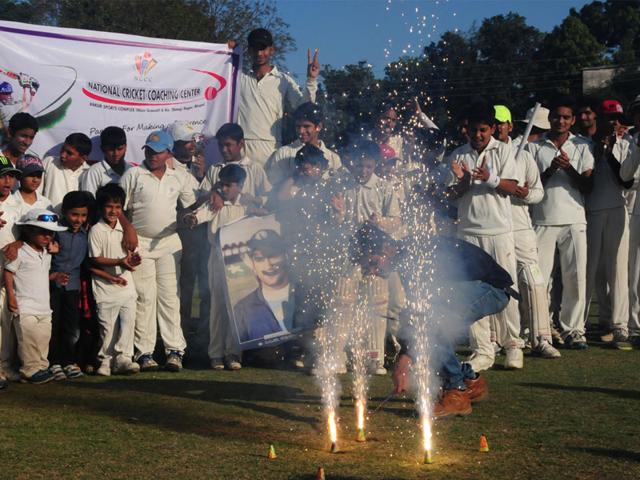 Young cricketers of National Cricket Coaching Centre burst crackers to celebrate India's win in World Cup, in Bhopal on Thursday. (Mujeeb Faruqui/HT photo)
