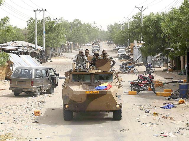 A-convoy-of-soldiers-from-Niger-and-Chad-drive-down-a-looted-street-in-the-recently-retaken-town-of-Damasak-Nigeria-Reuters-Photo