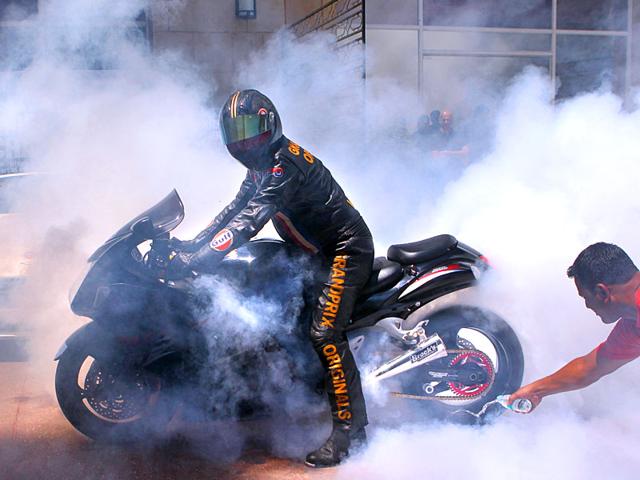 Darren Turner , the winner of 8th FIM European Championship, performs a demo run at the Aston Martin Racing and Drag racing, in Mumbai. (Satish Bate/HT photo)