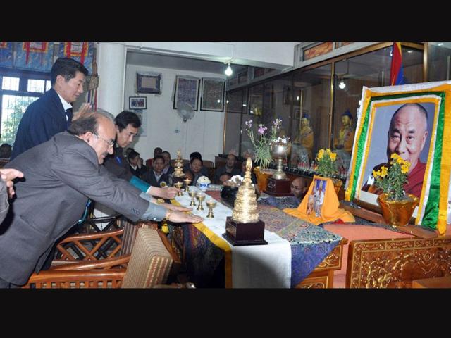 Tibetan PM in-exile, Lobsang Sangay and state health minister Thakur Koul Singh lighting lamp front of Dalai Lama's portrait on the occasion of 54th founding anniversary of Men-Tsee-Khang at Dharamsala. Shyam Sharma/HT
