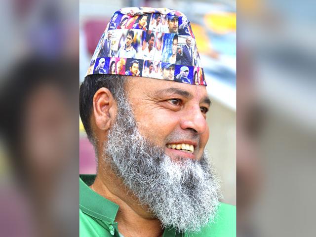 A Pakistani fan sports a cap with pictures of Indian captain M.S.Dhoni during the Pool B Cricket World Cup match between Pakistan and Zimbabwe in Brisbane, Australia, Sunday, March 1, 2015. (AP Photo)
