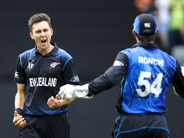 Trent Boult reacts after catching out Quentin de Kock as team mate Luke Ronchi joins him during their Cricket World Cup semi final in Auckland. (Reuters)