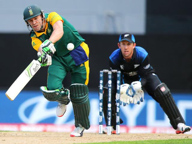 AB de Villiers plays a shot as Luke Ronchi watches during their Cricket World Cup semifinal in Auckland. (AP Photo/David Rowland)