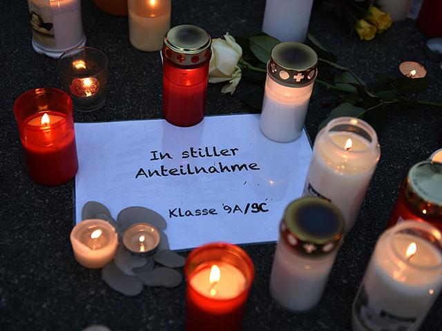 Germanwings-employees-cry-as-they-place-flowers-and-lit-candles-outside-the-company-headquarters-in-Cologne-Bonn-airport--Reuters