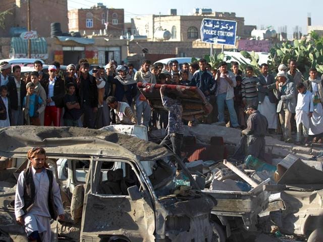 Yemenis-stand-at-the-site-of-a-Saudi-air-strike-against-Huthi-rebels-near-Sanaa-Airport-on-March-26-2015-which-killed-at-least-13-people-AFP-Photo