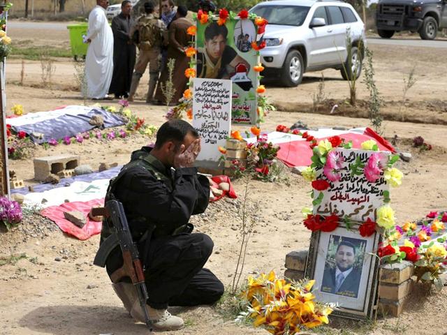 A-Sunni-fighter-from-the-al-Jabouri-tribe-weeps-in-front-of-the-grave-of-his-relative-killed-in-a-battle-with-Islamic-State-militants-AP-Photo
