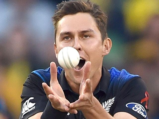 New Zealand bowler Trent Boult takes a catch off his own bowling to dismiss Australian batsman Aaron Finch during the 2015 Cricket World Cup final between Australia and New Zealand in Melbourne on March 29, 2015. AFP PHOTO