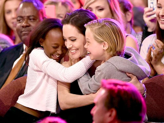 Angelina-Jolie-hugs-daughters--Zahara-Marley-Jolie-Pitt-L-and-Shiloh-Nouvel-Jolie-Pitt-R-after-winning-award-for-Favourite-Villain-in-Maleficent-during-Nickelodeon-s-28th-Annual-Kids-Choice-Awards-AFP