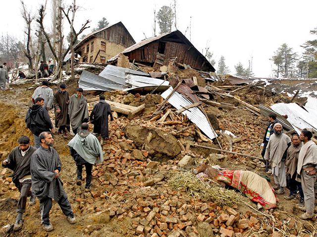 People-stand-amidst-the-rubble-after-a-hillside-collapsed-onto-a-house-at-Laden-village-of-Budgam-district-in-Jammu-and-Kashmir-March-30-2015-16-people-were-killed-in-the-mudslide-Reuters-Photo People-stand-amidst-the-rubble-after-a-hillside-collapsed-onto-a-house-at-Laden-village-of-Budgam-district-in-Jammu-and-Kashmir-March-30-2015-16-people-were-killed-in-the-mudslide-Reuters-Photo