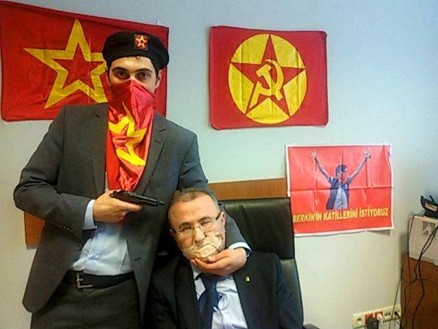 A-gunman-poses-with-prosecutor-Mehmet-Selim-Kiraz-with-a-gun-to-his-head-after-being-taken-hostage-in-his-office-in-a-court-house-in-Istanbul-A-far-left-Turkish-group-took-the-Istanbul-prosecutor-hostage-on-Tuesday-and-threatened-to-kill-him-prompting-special-forces-officers-to-enter-the-courthouse-and-police-to-evacuate-the-building-Reuters-Photo